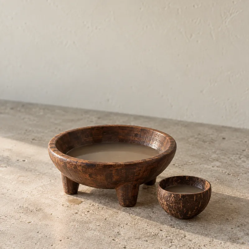 A carved wooden kava bowl and a coconut-shell cup